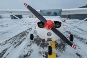 cessna parked with snow 